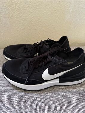 Nike women’s Black Low-Top Sneakers with White Swoosh